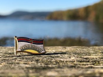 Close-up of deck chair on shore