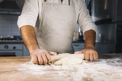 Midsection of chef preparing food