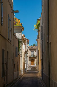 View of a narrow alley at the city center of nimes, in the french provence.