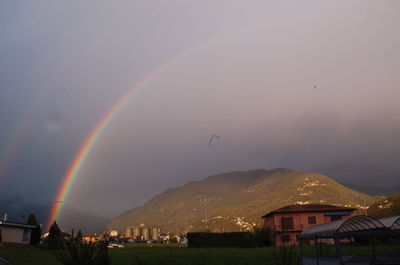 Rainbow over mountain against sky