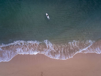 High angle view of bird flying over sea