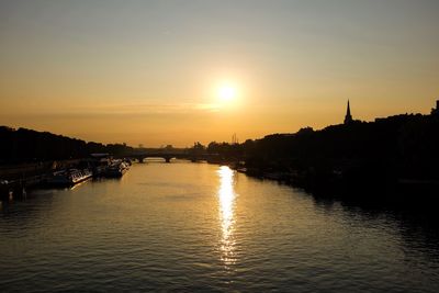 Scenic view of river at sunset