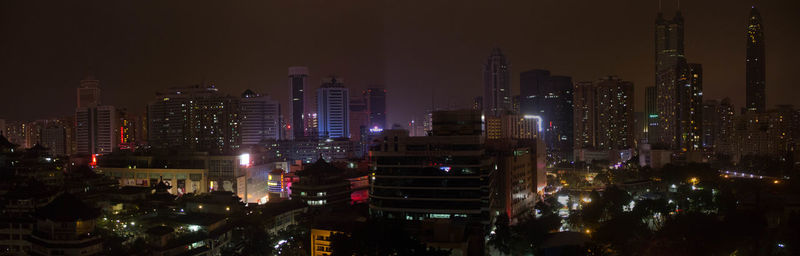 Aerial view of illuminated buildings in city at night