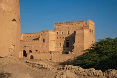 Low angle view of historical building against blue sky