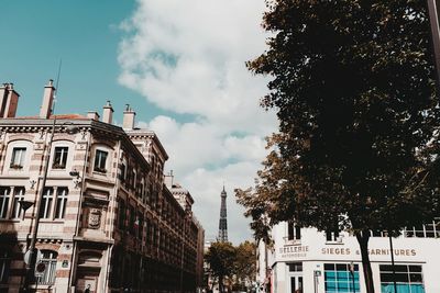 Low angle view of buildings against cloudy sky