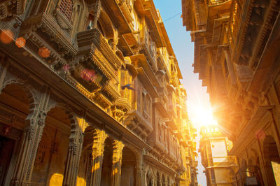 Low angle view of buildings against sky at sunset