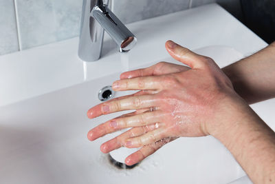 Close-up of woman hands in bathroom