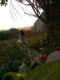 Woman standing by flower tree