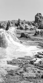 Rock formation on land against clear sky