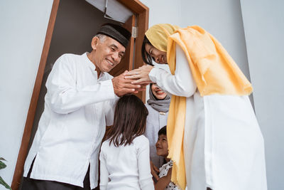 Rear view of couple holding hands