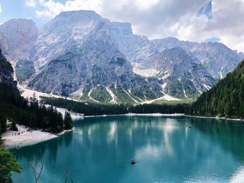 Scenic view of lake by mountains against sky