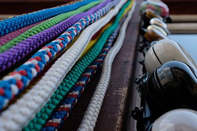 Close-up of colorful ropes by bells in market