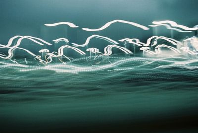 Close-up of light painting against blue sky