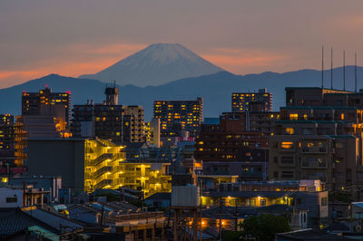 Illuminated cityscape against sky at night