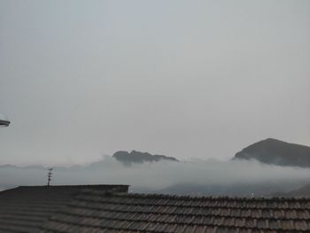 Low angle view of house roof against sky