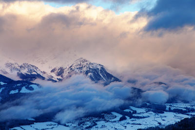 Scenic view of snowcapped mountains against sky during sunset