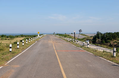 Empty road along calm sea