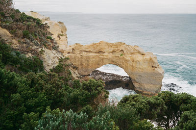 Rock formations by sea against sky