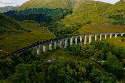 Glenfinnan historic rail viaduct in scottish highlands. full frame wide angle view in clouds day