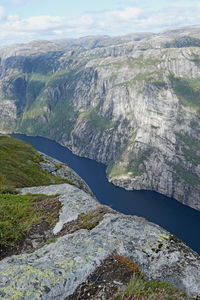 High angle view of river amidst mountains against sky