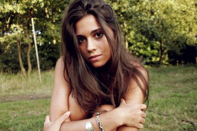 Portrait of young woman on field