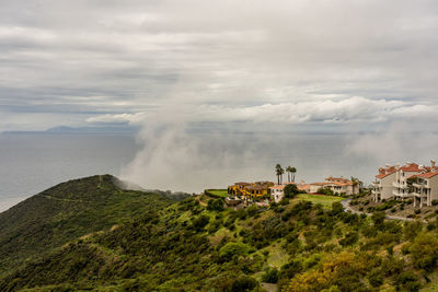 Scenic view of sea against buildings