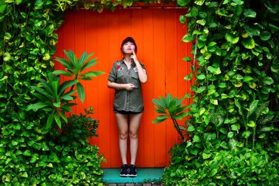 Woman standing by plants