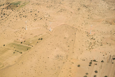 High angle view of land with wind turbines in desert