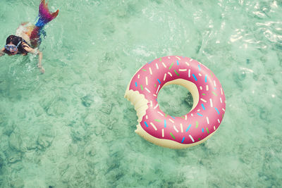 Girl swimming by inflatable ring