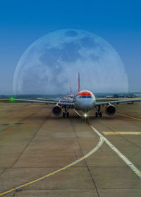 Airplane on runway against sky