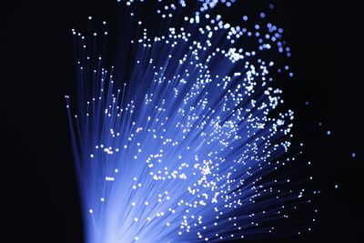 Close-up of fiber optic against black background