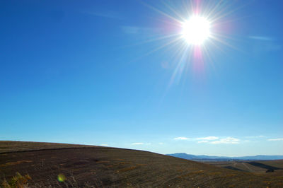 Scenic view of landscape against blue sky