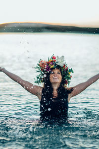 Woman wearing flowers in sea