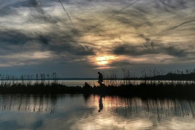 Scenic view of lake against sky during sunset