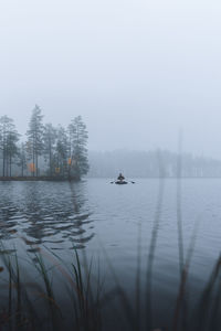 Scenic view of lake against sky during winter