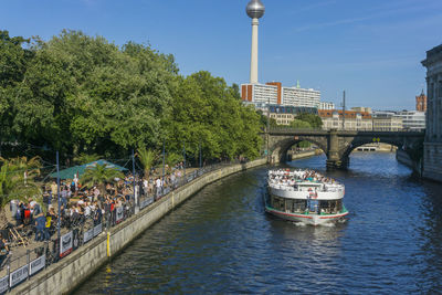 Bridge over river in city against clear sky