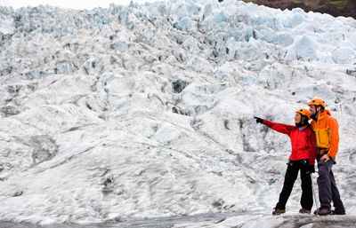 Full length of a young man standing in snow