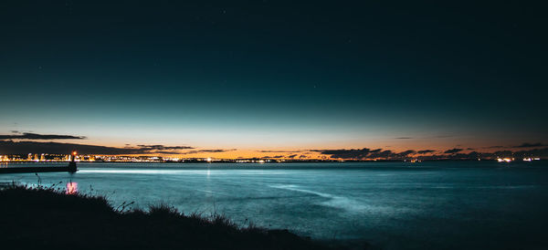 Scenic view of sea against sky at night