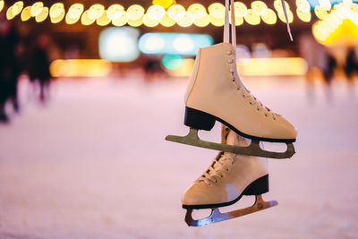 Close-up of ice skates hanging in rink