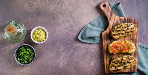 Sandwiches on rye bread with guacamole, fried mushrooms, tomatoes and dill top view web banner