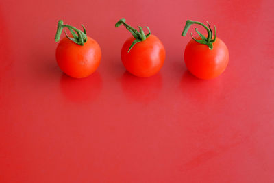 Close-up of tomatoes against red background