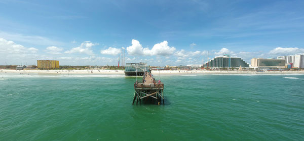 Scenic view of sea and buildings against sky