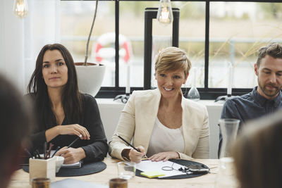 Smiling business people taking interview in office