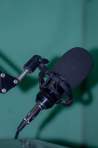 Close-up of camera on table against gray background