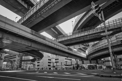 Low angle view of elevated road against buildings