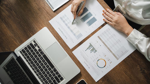 Midsection of businessman working on table