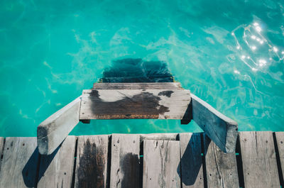 High angle view of wooden post by swimming pool