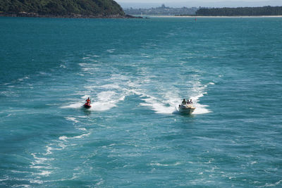 People riding jet boat in sea