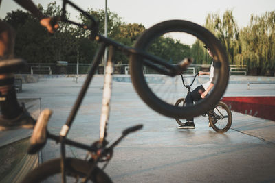 Cropped image of man performing stunt while cycling