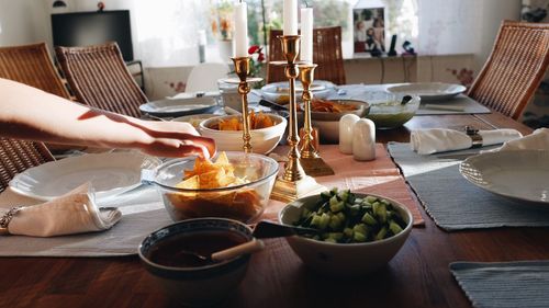 Cropped hand of person having food on table